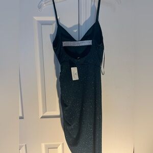 A dark green glitter knee length dress with a split. Perfect for homecoming!!